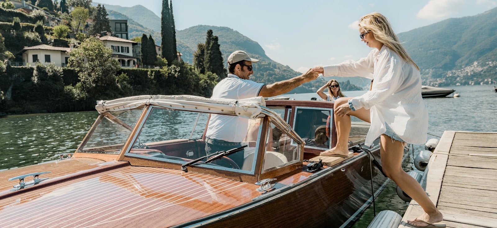 A tourist jumping on a boat during private como lake boat tour from Milan. A tourist jumping on a boat during private como lake boat tour from Milan.